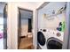 Convenient laundry area with modern washer and dryer, shelving, and access to the bathroom at 2602 Adelia Blvd, Deltona, FL 32725