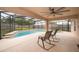 Outdoor living area featuring a sparkling pool, a covered patio, and comfortable seating at 2602 Adelia Blvd, Deltona, FL 32725