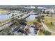 Aerial view of a community featuring ponds, a building, a golf course, palm trees and lush landscaping at 2602 Shirehall Ln, Winter Garden, FL 34787
