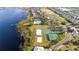 Aerial view of the community featuring waterfront homes, a pool, recreational facilities and a golf course at 2602 Shirehall Ln, Winter Garden, FL 34787
