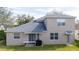 Exterior view of the home's rear elevation, showcasing the yard and patio at 2602 Shirehall Ln, Winter Garden, FL 34787