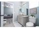 Bright bathroom featuring a large mirror, toilet, and view to the bedroom in the house at 2602 Shirehall Ln, Winter Garden, FL 34787