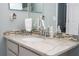The bathroom features a sleek marble counter and backsplash, accented by updated fixtures and lighting at 2602 Shirehall Ln, Winter Garden, FL 34787