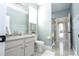Clean bathroom with vanity, shower, and tile floors in a modern-styled home at 2602 Shirehall Ln, Winter Garden, FL 34787
