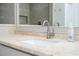 Close up of bathroom vanity sink with light stone countertop and gray cabinets at 2602 Shirehall Ln, Winter Garden, FL 34787