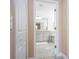 View of a bathroom through a doorway with gray cabinets, a white tub and gray flooring at 2602 Shirehall Ln, Winter Garden, FL 34787