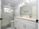 Bright bathroom featuring double vanity, marble counters, and glass enclosed shower at 2602 Shirehall Ln, Winter Garden, FL 34787