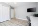 Bedroom with light gray walls, wood floors, a work desk, and closet at 2602 Shirehall Ln, Winter Garden, FL 34787