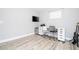 Bedroom featuring wood floors, a TV, desk, and mini-fridge at 2602 Shirehall Ln, Winter Garden, FL 34787