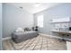 Bedroom with desk, TV, stationary bike and calming blue walls in the home at 2602 Shirehall Ln, Winter Garden, FL 34787