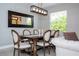 Elegant dining room with modern chandelier and large mirror, bathed in natural light at 2602 Shirehall Ln, Winter Garden, FL 34787