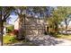 Charming tan two-story home with a two car garage and mature landscaping near a streetlight at 2602 Shirehall Ln, Winter Garden, FL 34787