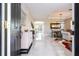 Bright foyer with marble floors leading into a dining room and living area with modern decor at 2602 Shirehall Ln, Winter Garden, FL 34787