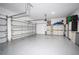 Spacious garage with epoxy flooring and bright lighting at 2602 Shirehall Ln, Winter Garden, FL 34787
