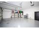 Spacious two car garage with storage shelves and epoxy flooring at 2602 Shirehall Ln, Winter Garden, FL 34787