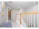 Upstairs hallway with wood-look floors, staircase and natural light streaming through the house at 2602 Shirehall Ln, Winter Garden, FL 34787