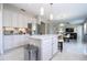 Well-lit kitchen with a marble island, stainless appliances, and modern finishes at 2602 Shirehall Ln, Winter Garden, FL 34787