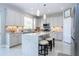 Beautiful, modern kitchen with white cabinets, mosaic backsplash, and island seating at 2602 Shirehall Ln, Winter Garden, FL 34787