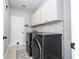 Laundry room with a washer and dryer, sink, and white upper cabinets at 2602 Shirehall Ln, Winter Garden, FL 34787