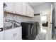Well lit laundry room featuring modern washer and dryer and sink at 2602 Shirehall Ln, Winter Garden, FL 34787