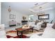 Spacious living room with marble floors, neutral furniture, and a decorative pendant light at 2602 Shirehall Ln, Winter Garden, FL 34787