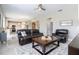 Living room with eat in kitchen and dining area with leather couches and ceilings fan at 2602 Shirehall Ln, Winter Garden, FL 34787