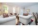 Cozy living room with plush sofas, decorative rug, and inviting ambiance at 2602 Shirehall Ln, Winter Garden, FL 34787