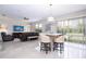 Open concept with eat-in counter, living room, and sliding door access to screened patio at 2602 Shirehall Ln, Winter Garden, FL 34787