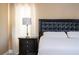Close up of the main bedroom nightstand with lamp, charging dock and decor at 2602 Shirehall Ln, Winter Garden, FL 34787