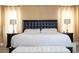 Close up of the main bedroom with a large bed and matching nightstands with lamps at 2602 Shirehall Ln, Winter Garden, FL 34787