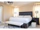 The main bedroom features a dark wood headboard and matching nightstands and curtains at 2602 Shirehall Ln, Winter Garden, FL 34787