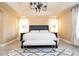 Spacious main bedroom features a comfortable bench and a decorative chandelier at 2602 Shirehall Ln, Winter Garden, FL 34787