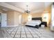 Spacious main bedroom with trey ceilings, elegant chandelier, and plush carpet at 2602 Shirehall Ln, Winter Garden, FL 34787