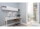 Home office features desk, shelving, and view into the nearby bathroom at 2602 Shirehall Ln, Winter Garden, FL 34787