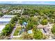 Aerial view of the home showcases the backyard pool and mature trees surrounding the property at 261 West Citrus St, Altamonte Springs, FL 32714