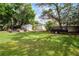 Spacious backyard featuring an outbuilding, garden, and mature trees; perfect for outdoor activities at 261 West Citrus St, Altamonte Springs, FL 32714