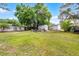 Large backyard featuring an outbuilding, garden, and mature trees; perfect for outdoor activities at 261 West Citrus St, Altamonte Springs, FL 32714