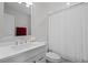 Modern bathroom with a white vanity, faucet, toilet, mirror, and a shower with curtain at 261 West Citrus St, Altamonte Springs, FL 32714