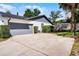Spacious driveway leading to a two-car garage, complemented by mature trees and a basketball hoop at 261 West Citrus St, Altamonte Springs, FL 32714