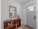 Inviting entryway with a decorative mirror, wooden shelving, and a stylish gray front door at 261 West Citrus St, Altamonte Springs, FL 32714