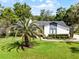 Well-maintained home with a lush green lawn and mature trees, showcasing curb appeal and a welcoming atmosphere at 261 West Citrus St, Altamonte Springs, FL 32714