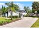 Charming single-story home featuring manicured landscaping, a spacious driveway, and a gray and white color scheme at 261 West Citrus St, Altamonte Springs, FL 32714