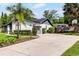 Charming single-story home featuring manicured landscaping, a spacious driveway, and a gray and white color scheme at 261 West Citrus St, Altamonte Springs, FL 32714