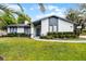 Inviting single-story home with a well-maintained lawn and walkway, accented by mature trees and lush landscaping at 261 West Citrus St, Altamonte Springs, FL 32714