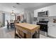 Kitchen with stainless appliances, butcher block island, and views into the dining room at 261 West Citrus St, Altamonte Springs, FL 32714