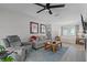 Comfortable living room features a ceiling fan, couches, sports memorabilia, and tile flooring at 261 West Citrus St, Altamonte Springs, FL 32714
