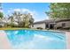 Backyard view of a sparkling pool with access to the home's covered patio and outdoor seating area at 261 West Citrus St, Altamonte Springs, FL 32714