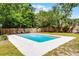Inviting backyard pool with lounge chairs and surrounded by lush greenery and a privacy fence at 261 West Citrus St, Altamonte Springs, FL 32714