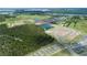 An aerial view showcasing the community's layout with ponds, lush greenery, and newly constructed homes at 2672 Great Heron Ave, St Cloud, FL 34773