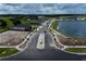 Scenic street view within the community, featuring a serene pond and newly constructed homes at 2672 Great Heron Ave, St Cloud, FL 34773